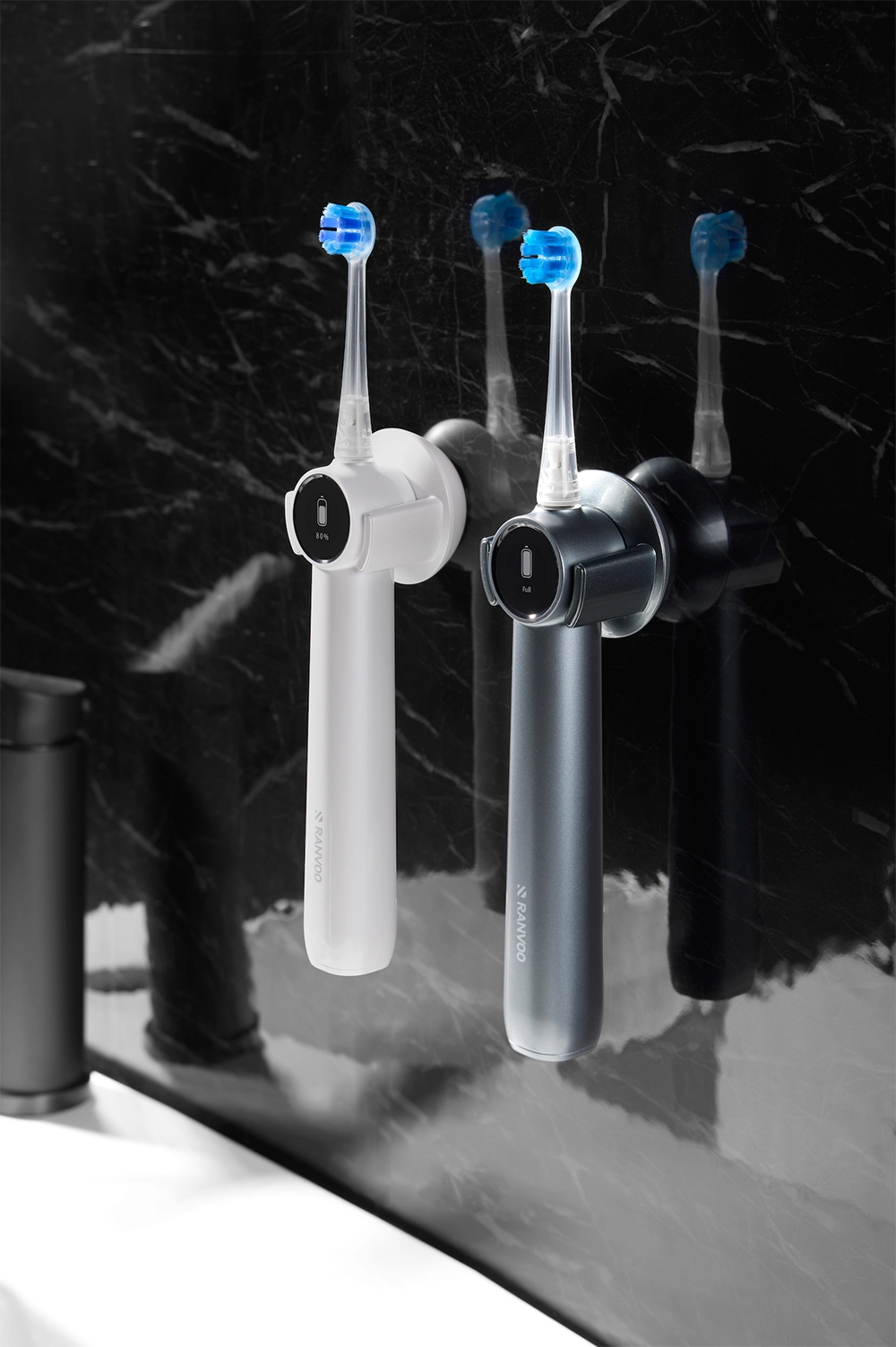 Two AirJet X5s are magnetically attached to the wireless wall-mounted magnetic charger